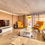 Spacious and stylish living room featuring yellow armchairs and elegant design.