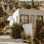 Contemporary house nestled in a sunlit rocky outdoor setting, perfect for architecture lovers.